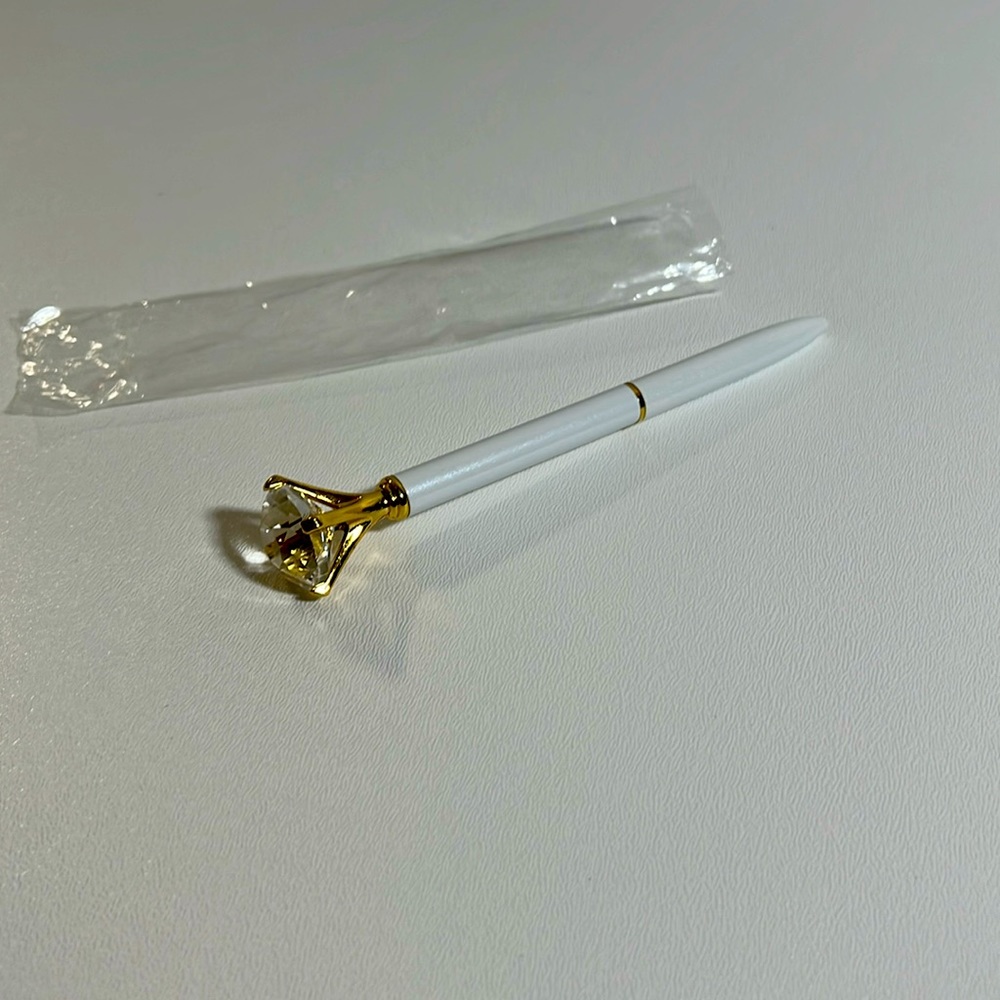 Ink pen with crystal ring.